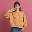 ピンク ラテ(PINK-latte)の落書き風プリント短丈プルオーバー オレンジ(066)